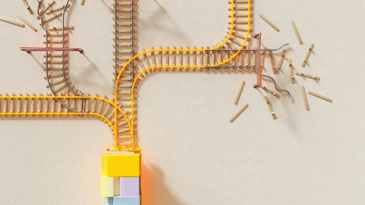 A train approaching a complicated rail crossing. Some rails end  shortly after, some continue.