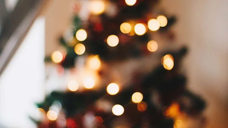 A blurry picture of a christmas tree with lights. 