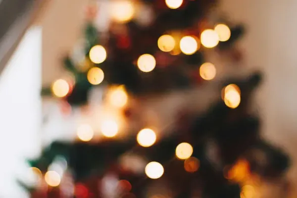 A blurry picture of a christmas tree with lights. 