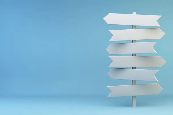 Das Bild zeigt einen weißen Wegweiser vor einem blauen Hintergrund.