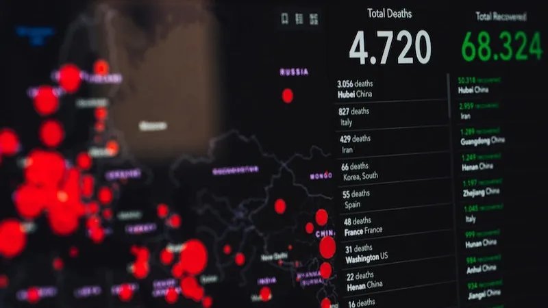 Photo of a dashboard showing Covid data. On the left, it shows a bubble map from Europe. On the right, there are two columns, one with deaths and one with the number of recovered people in different cities. The total number of deaths displayed is 4720.